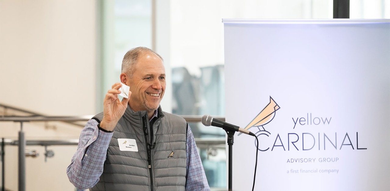 CEO smiles at crowd during a Yellow Cardinal event