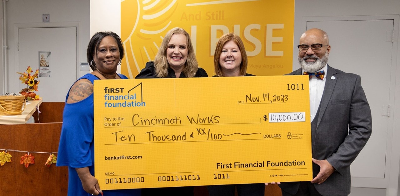First Financial associates pose with an oversized check for Columbus, IN-area nonprofits