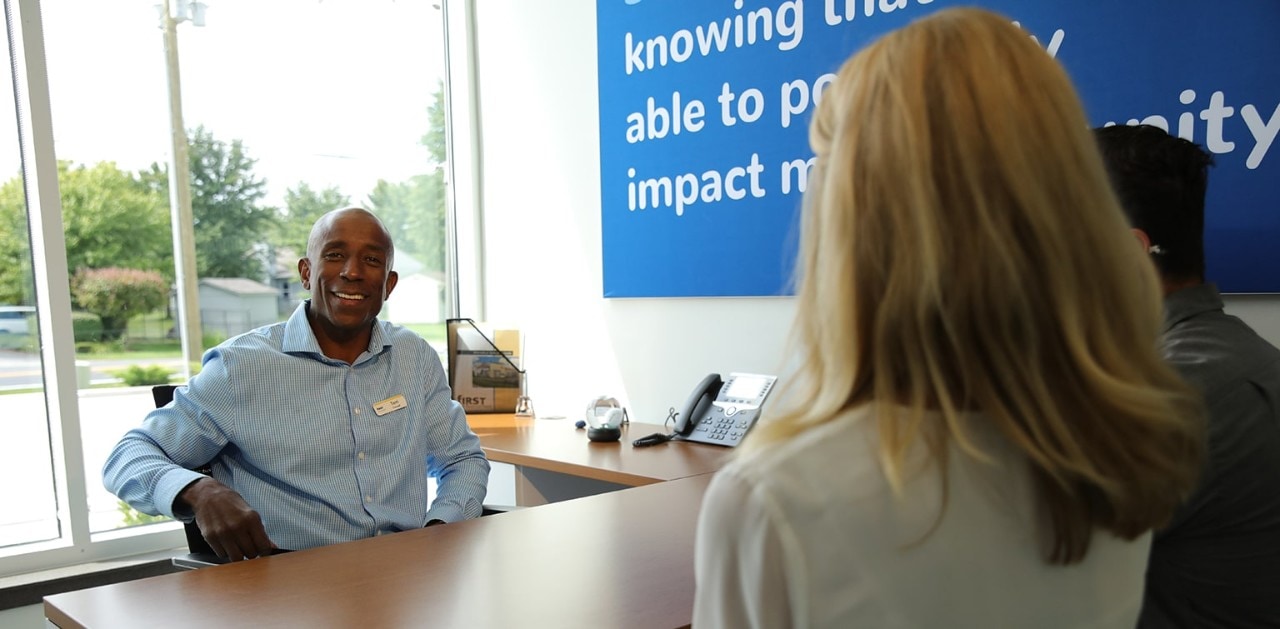 African-American male First Financial relationship manager meeting with young couple