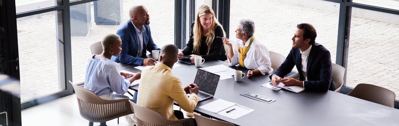 Group of colleagues conversing in a conference room