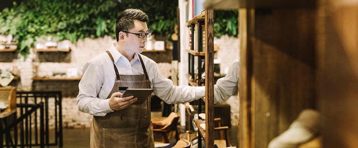 Man holding digital tablet while working in shoe store