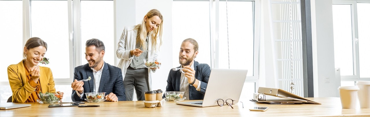 Employees eating boxed lunches at business meeting