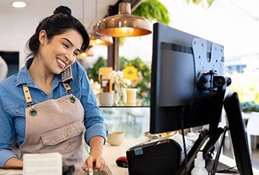 Female coffee shop owner taking order over the phone