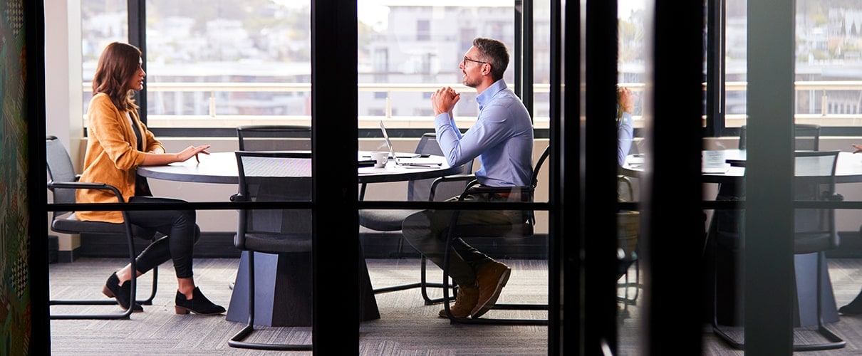 Male and female businesspeople meeting in small conference room