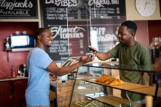 Small business owner takes credit card payment from customer