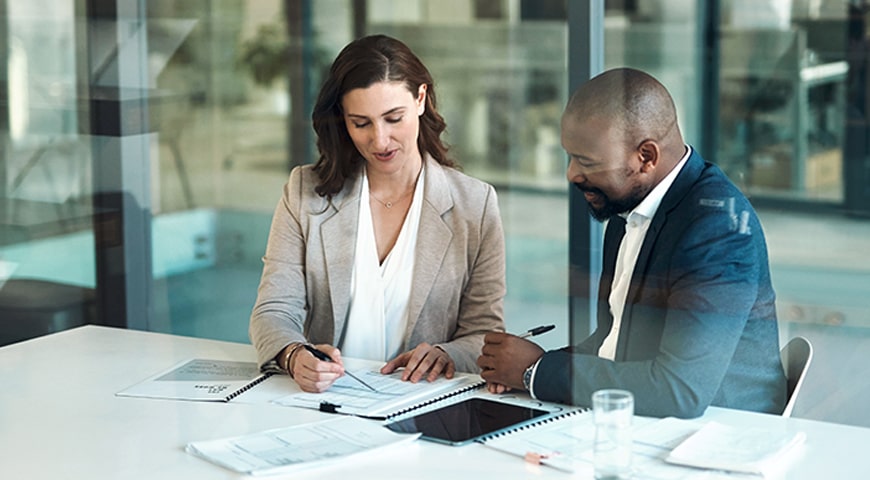Two colleagues reviewing a financial plan