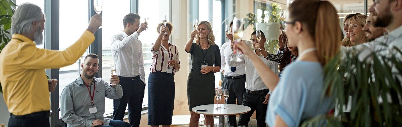 Diverse group of employees toasting to a retiring co-worker