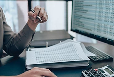 Employee looks over analytics on desktop