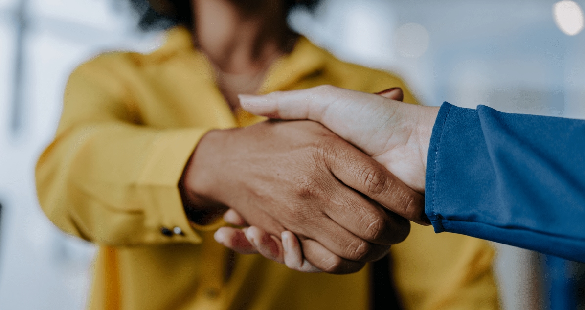 Close up image of two people shaking hands