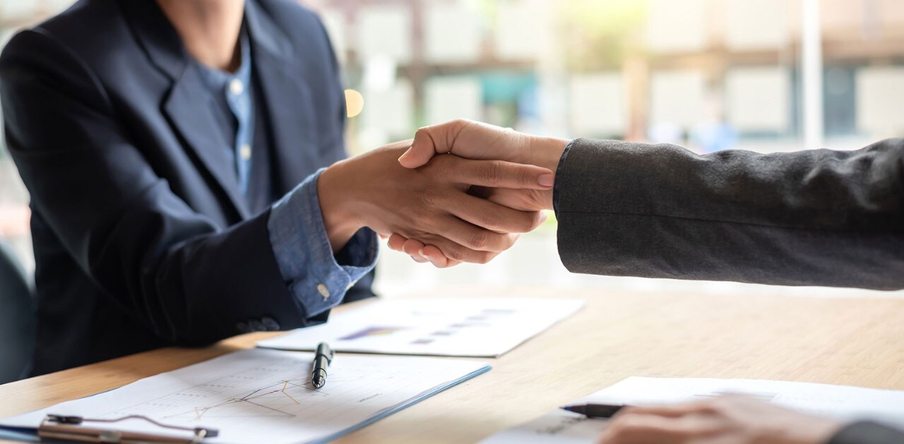 Banker and small business owner shaking hands