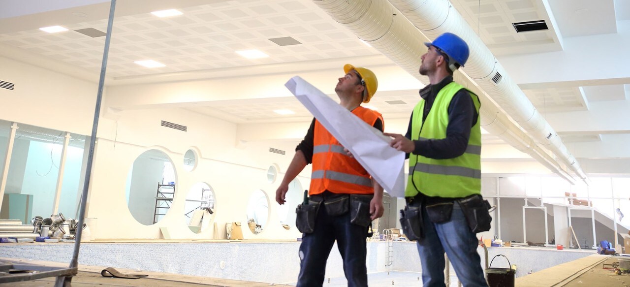 Construction team surveying business expansion space