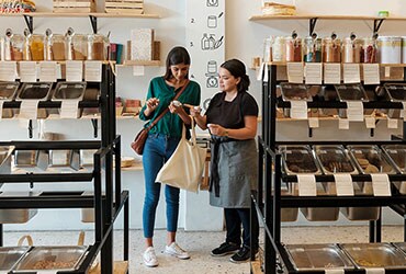 Female business owner assisting customer