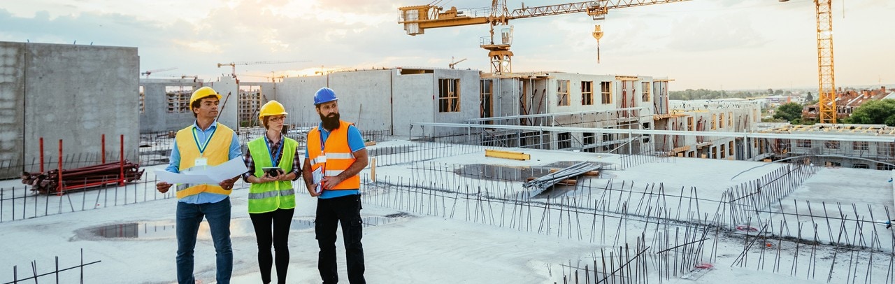 Employees working on construction site, wearing protective equipment