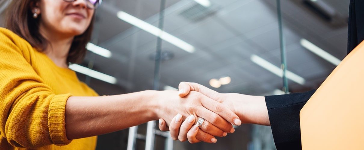 Handshake between businesswoman and female banker