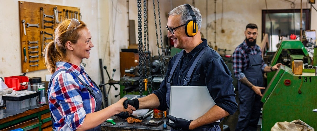 Manufacturing employee shaking hands with manager