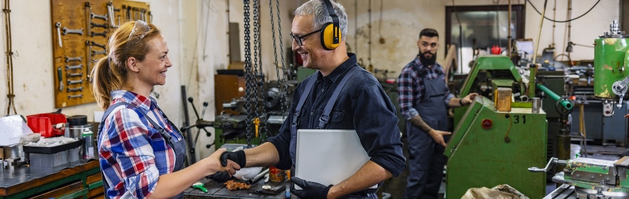 Manufacturing employee shaking hands with manager