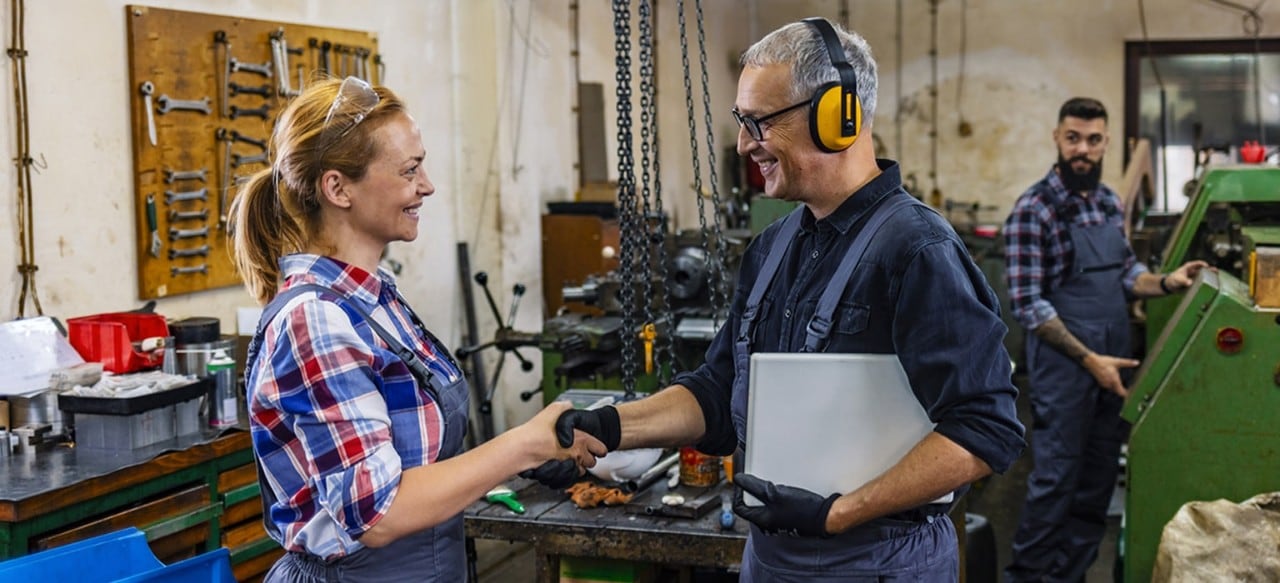 Manufacturing employee shaking hands with manager