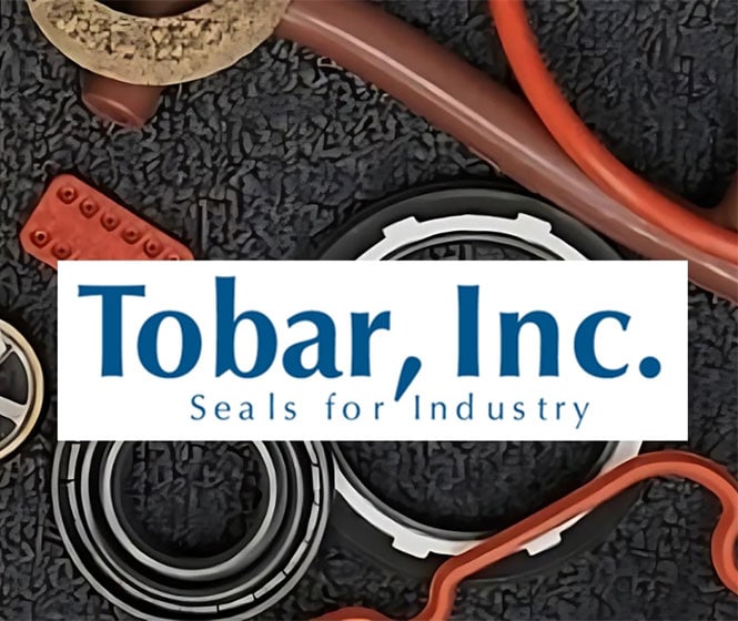 Industrial seals of different shapes and sizes arranged on a black carpet with and overlay of the logo of Tobar Inc. 