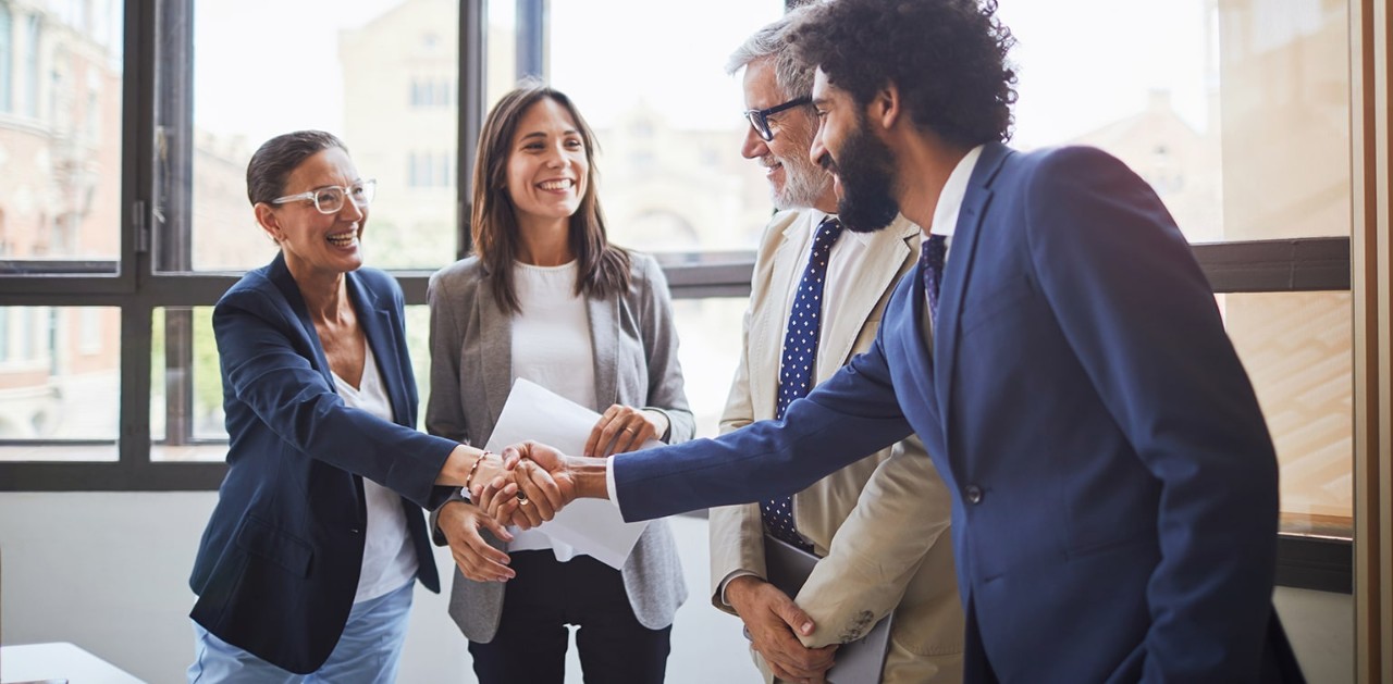 Business team shaking hands with banker