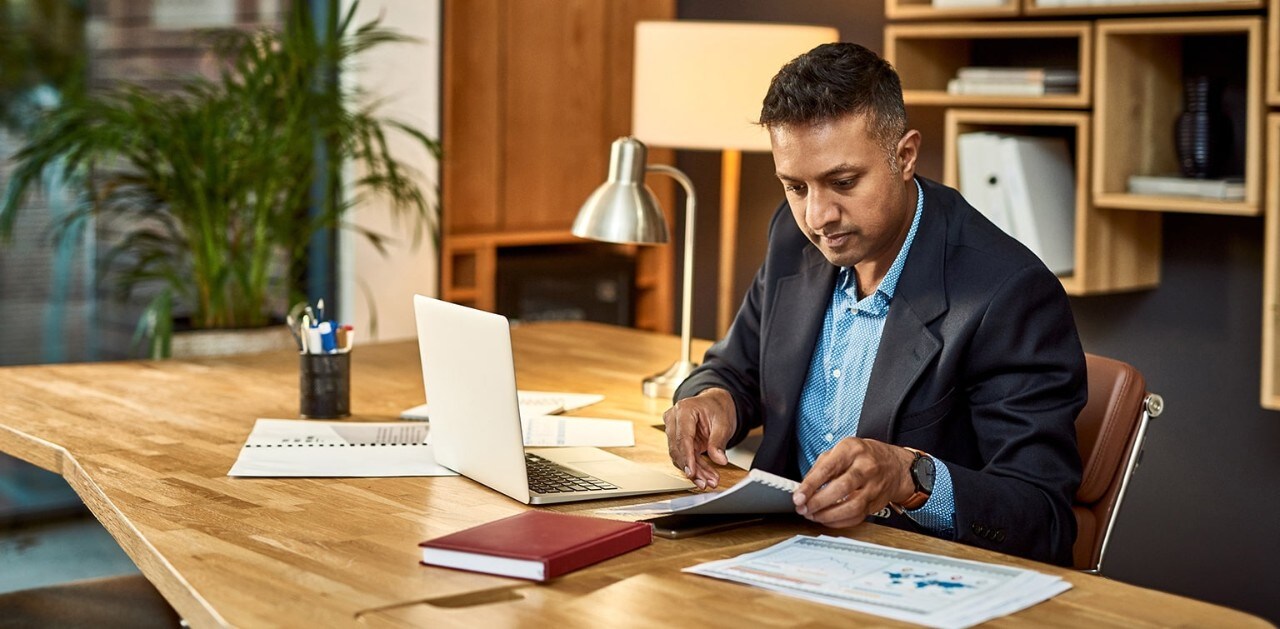 Business owner reviewing finances at desk