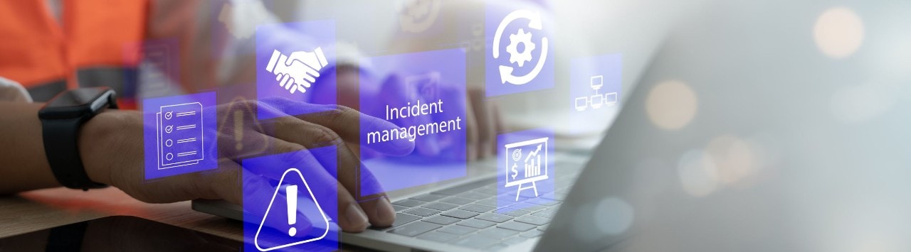 Hands typing on a laptop with symbols that indicate phases of incident response management