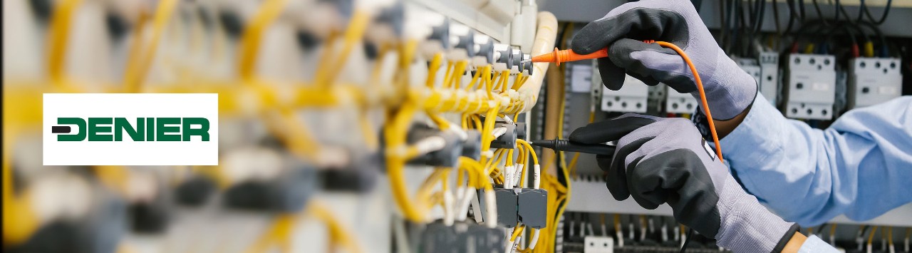 Technician working on electrical equipment, with Denier logo