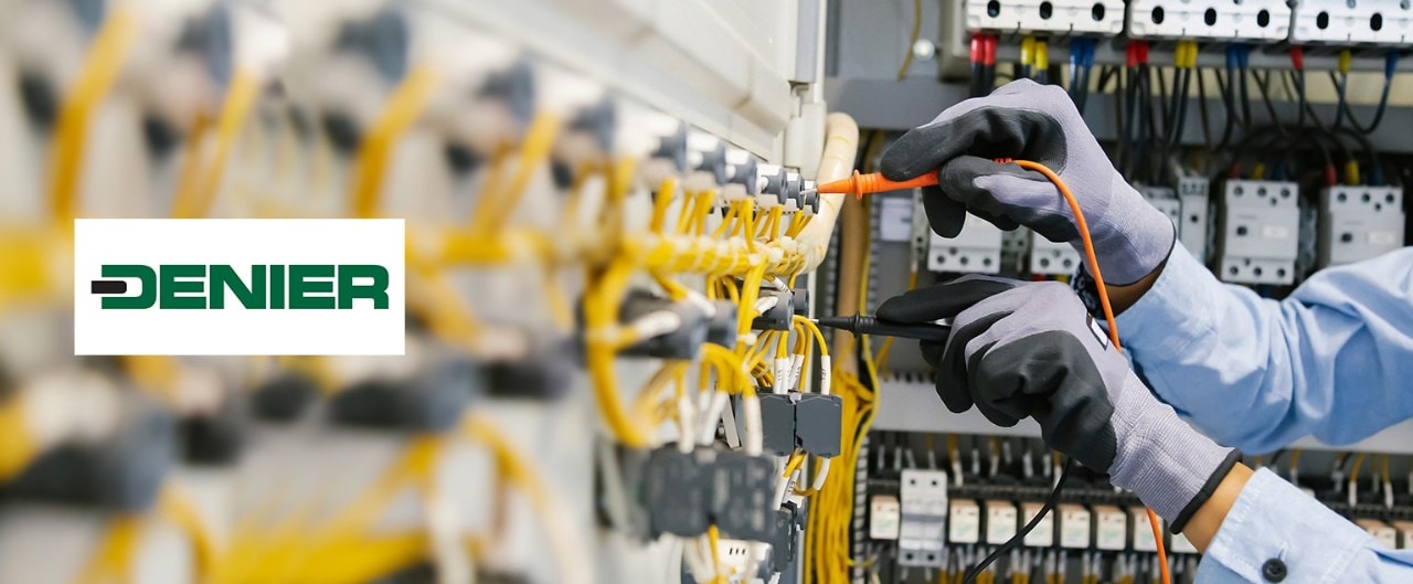 Technician working on electrical equipment, with Denier logo