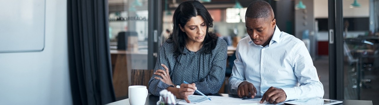 Business associates reviewing documents in conference room