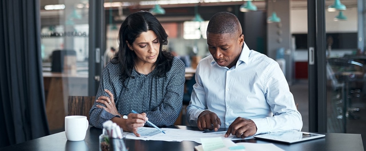 Business associates reviewing documents in conference room