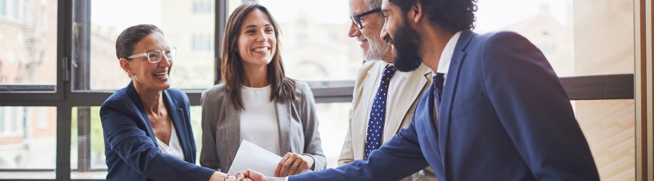 Business team shaking hands with banker