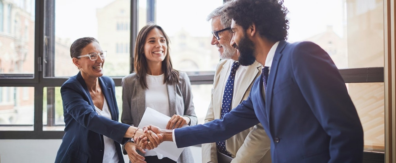 Business team shaking hands with banker