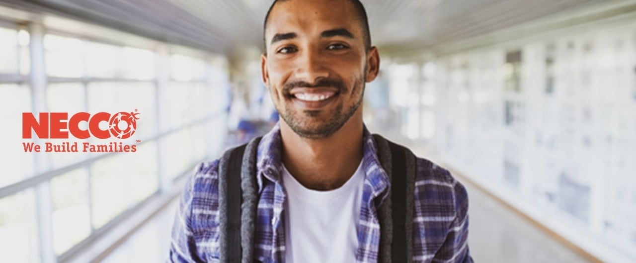 Young Hispanic man holding backpack, with Necco logo