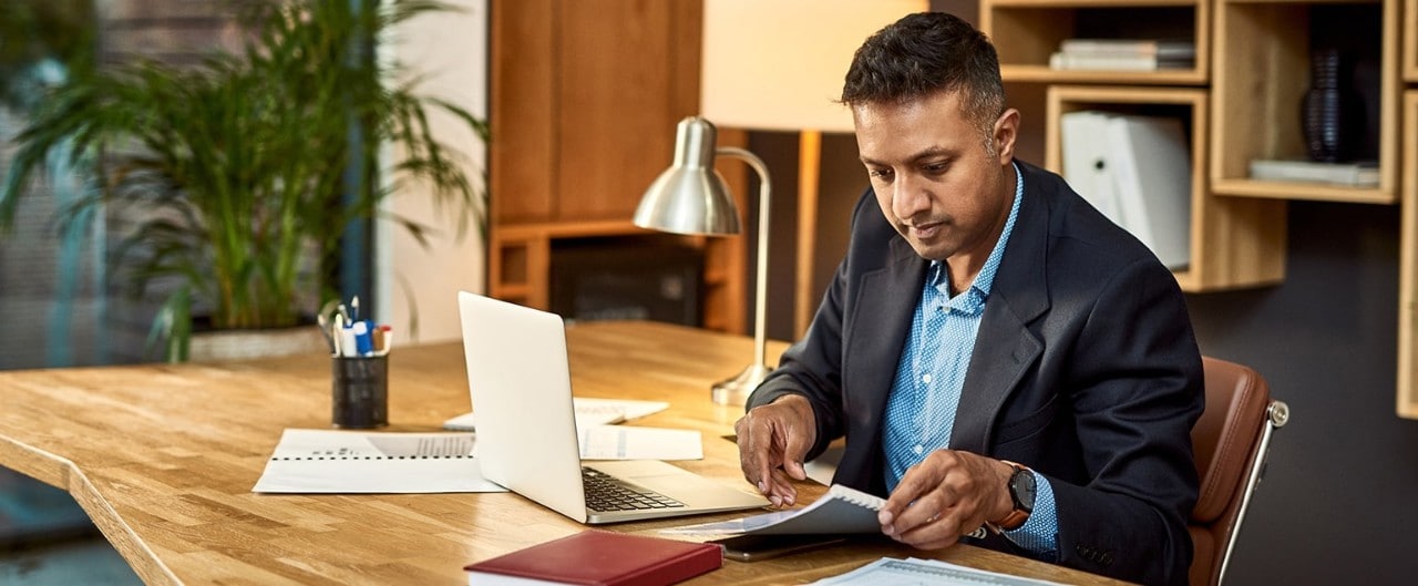 Business owner reviewing finances at desk