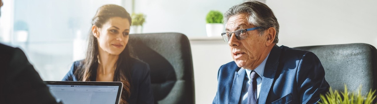 Business colleagues conversing at a conference table