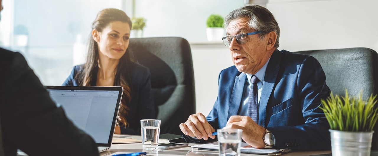 Business colleagues conversing at a conference table