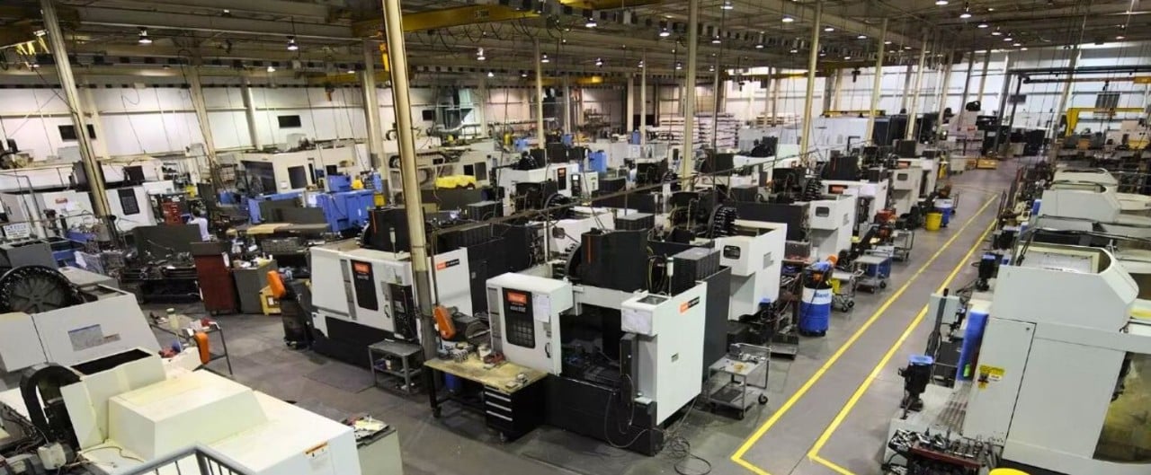 Wide view of manufacturing plant with rows of machines