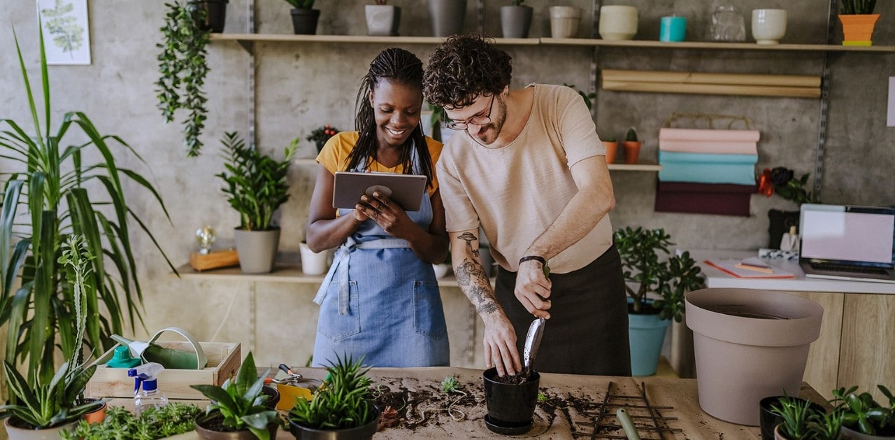 Multiracial business partners using tablet in florist shop