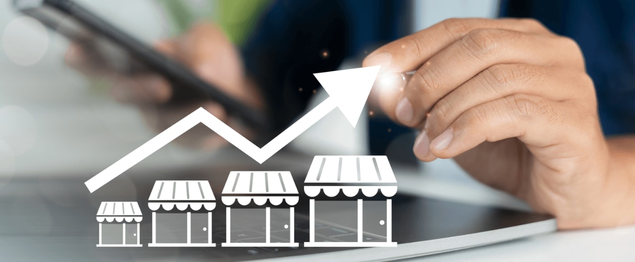 business owner points to a graphic showing business growth