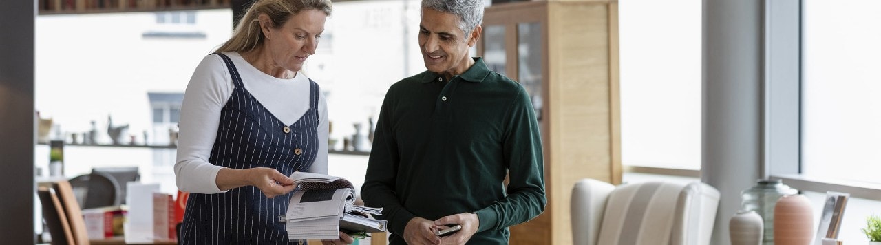 Store employee assisting customer in furniture store