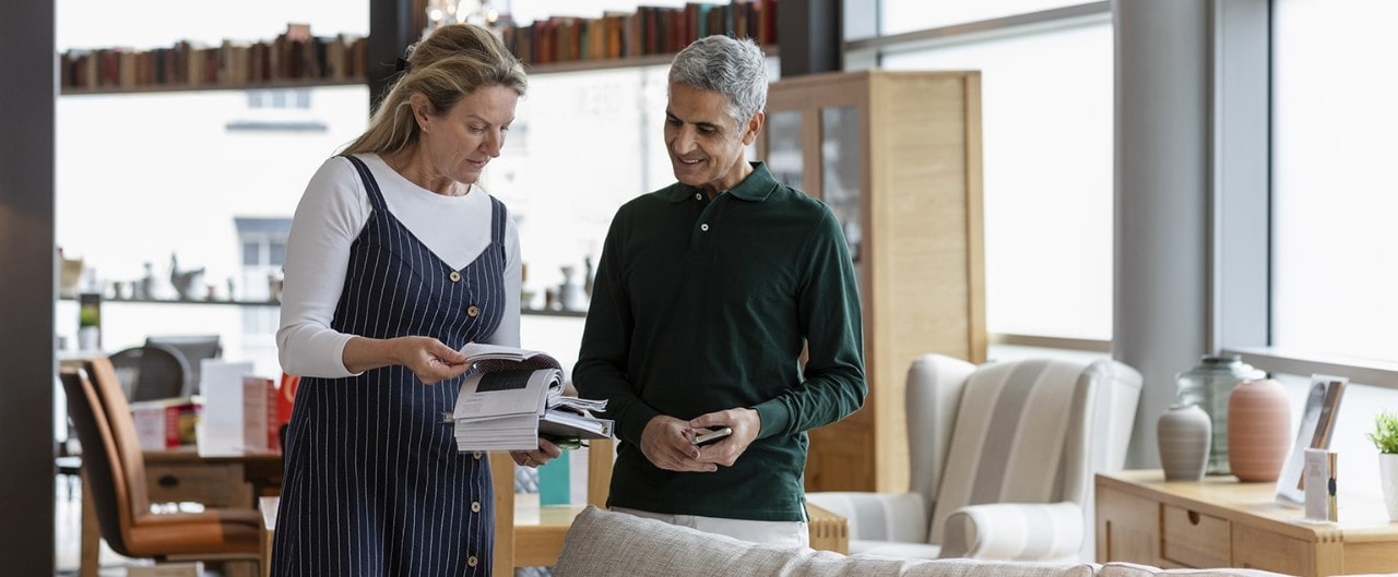 Store employee assisting customer in furniture store