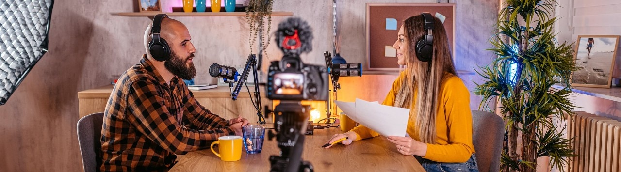 Business owner sitting at table participating in podcast