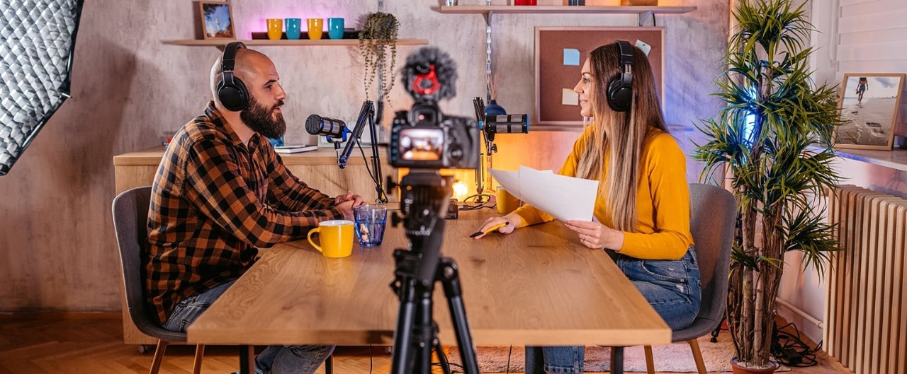 Business owner sitting at table participating in podcast