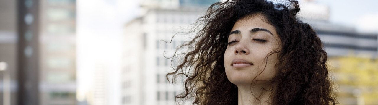 Businesswoman taking mental break outside in downtown setting