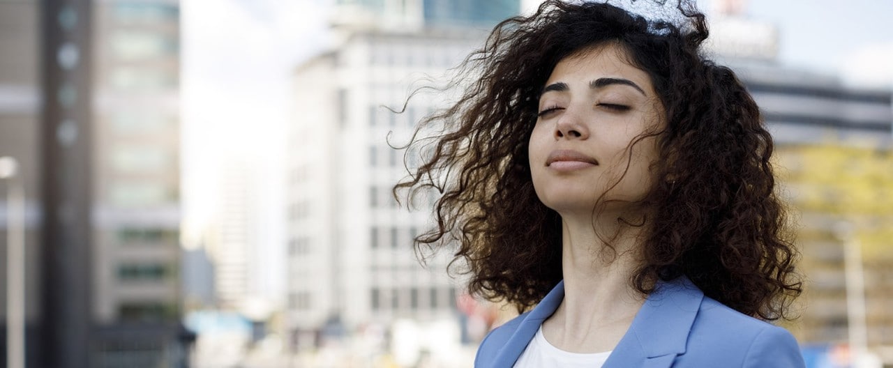 Businesswoman taking mental break outside in downtown setting