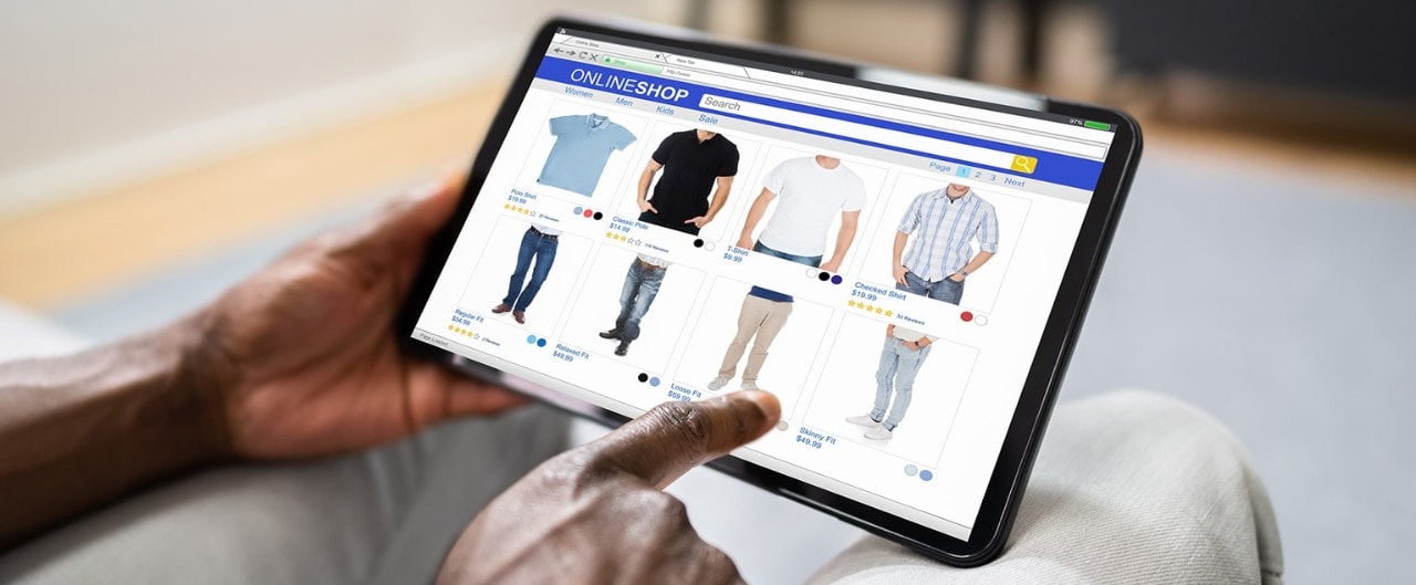 Man shopping for complementary clothing items on tablet