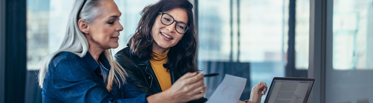 Woman business owner reviewing finances with her successor