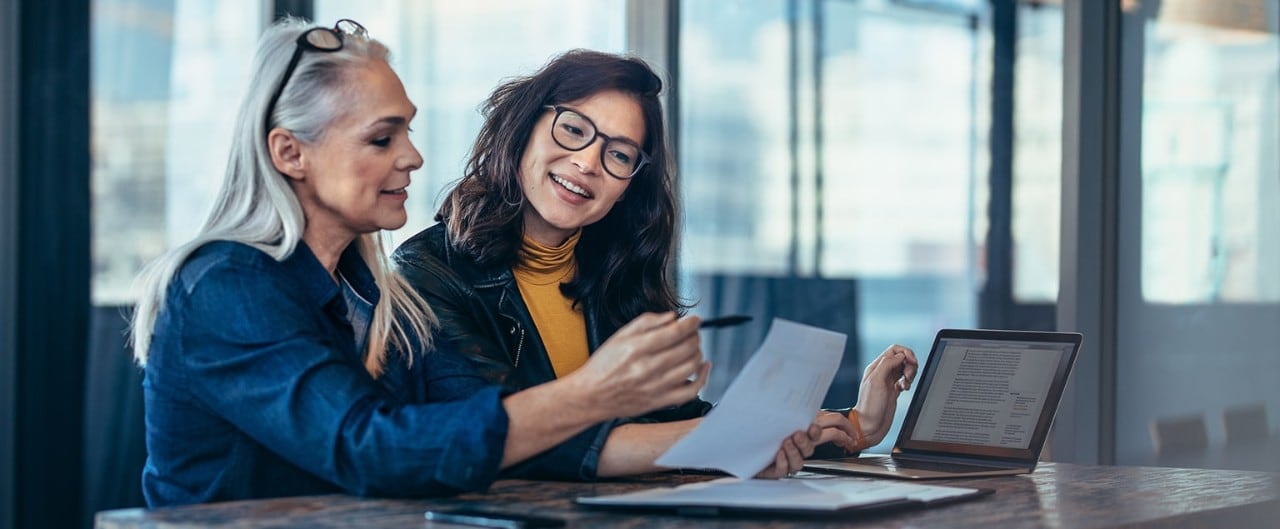 Woman business owner reviewing finances with her successor