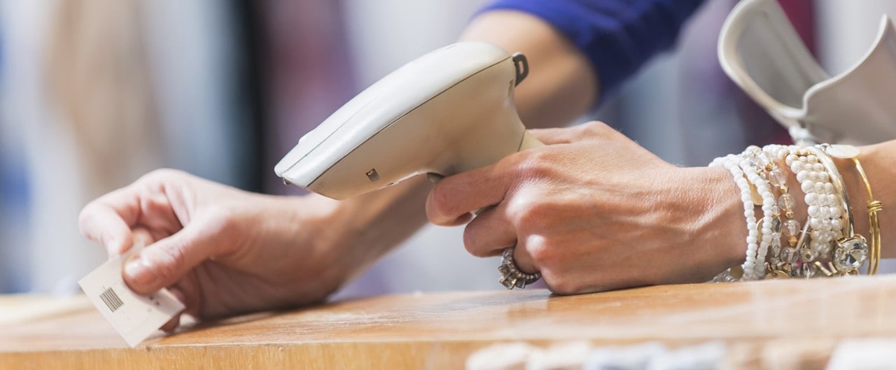 Sales clerk scanning a price tag