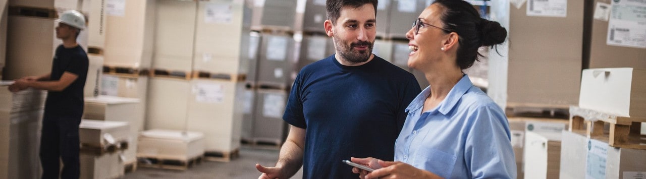 Female wholesale owner speaking to employee