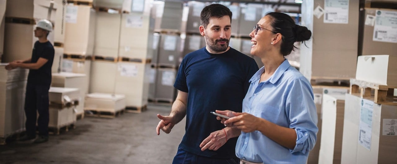 Female wholesale owner speaking to employee